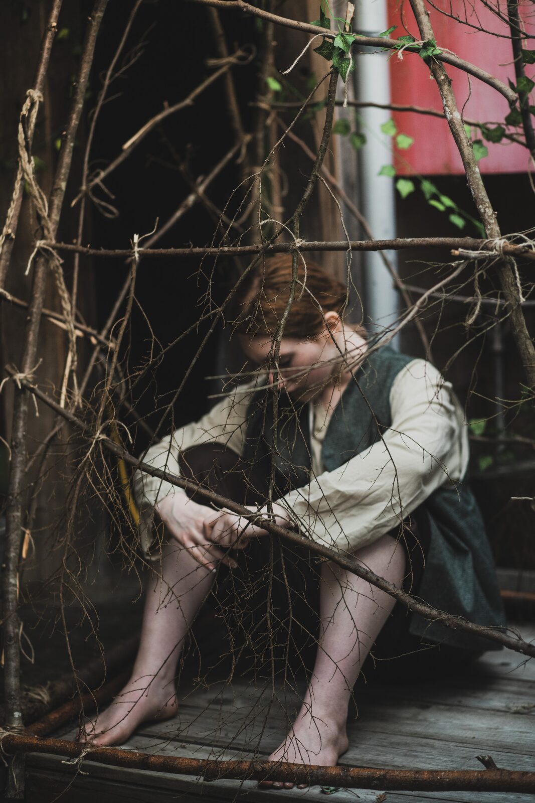Hansel crouched behind a tangle of branches