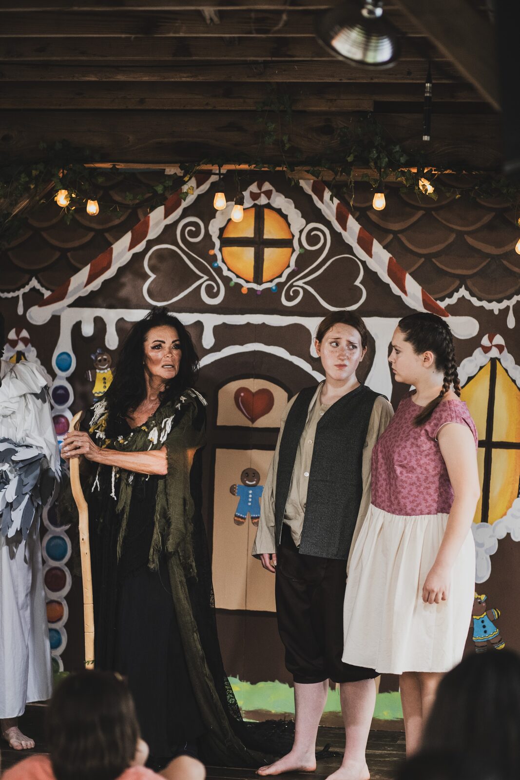 The witch confronts Hansel and Gretel